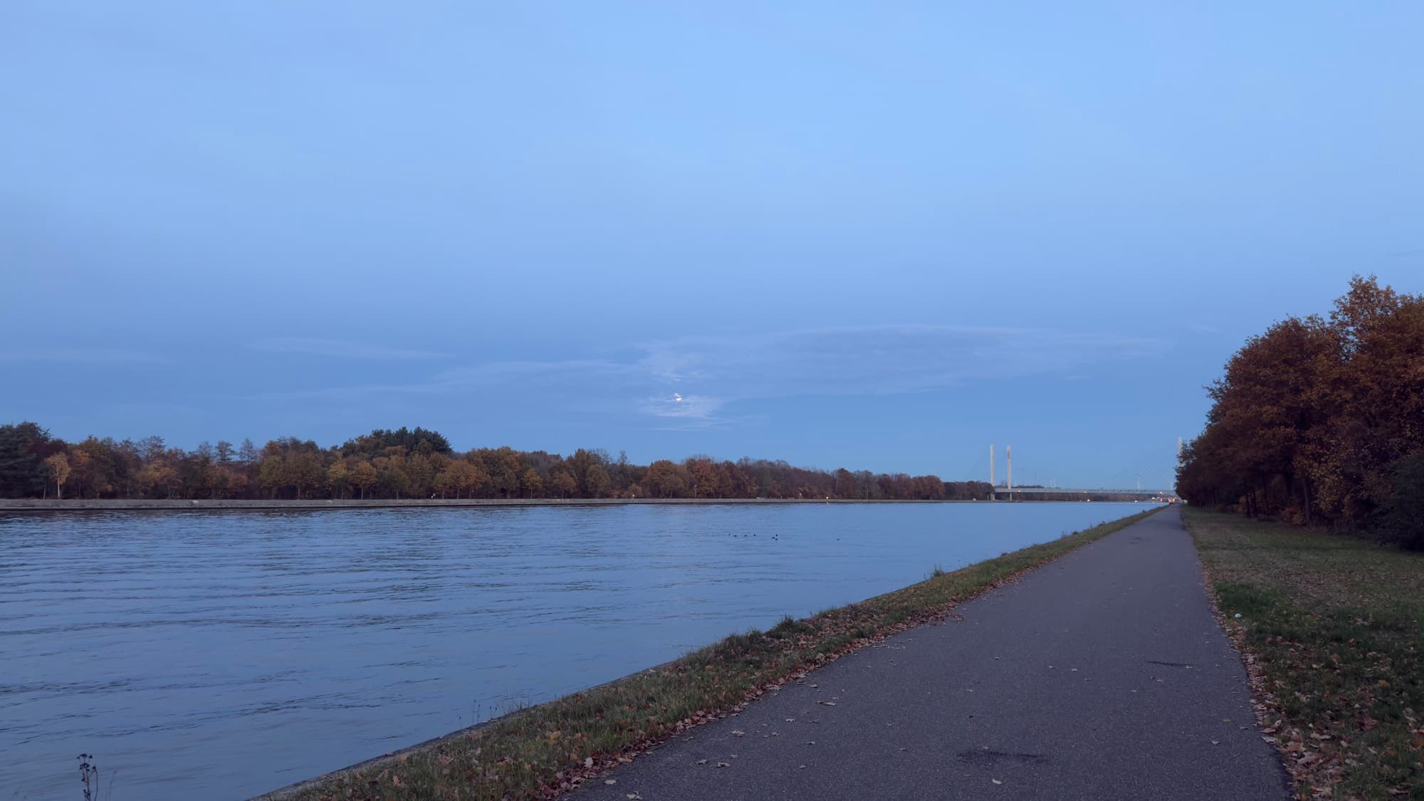 Albert Canal towpath at blue hour with a distant bridge, Hasselt