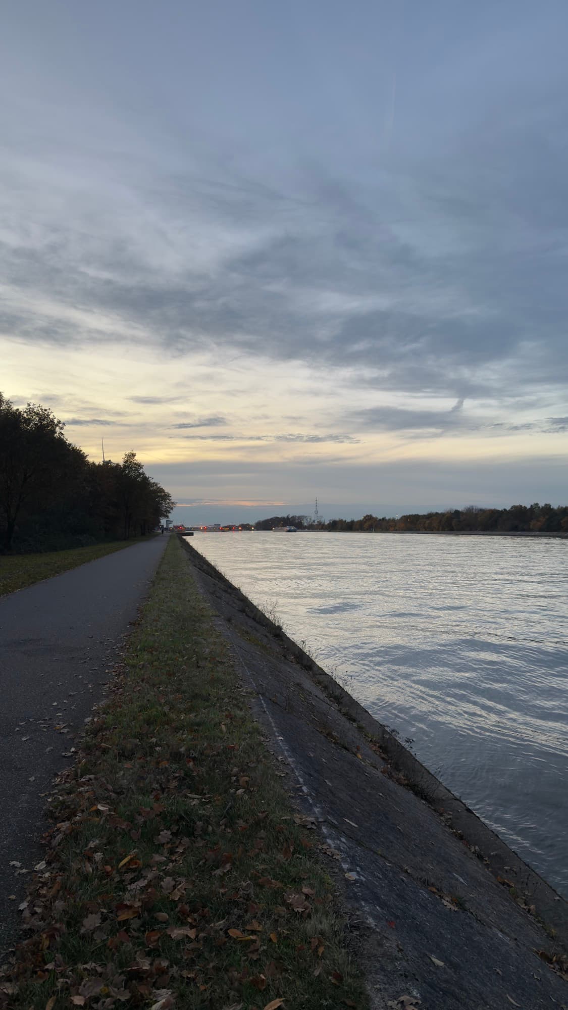 Albert Canal towpath at sunset with autumn leaves, Hasselt