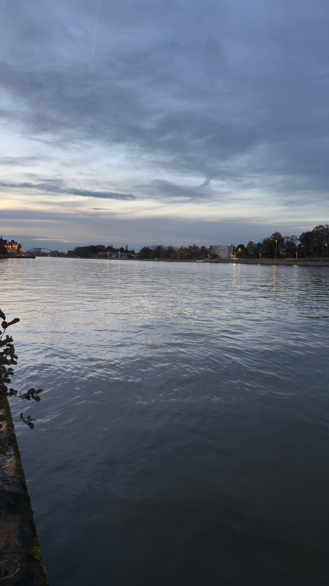 Wide still water of the Albert Canal at dusk, Hasselt
